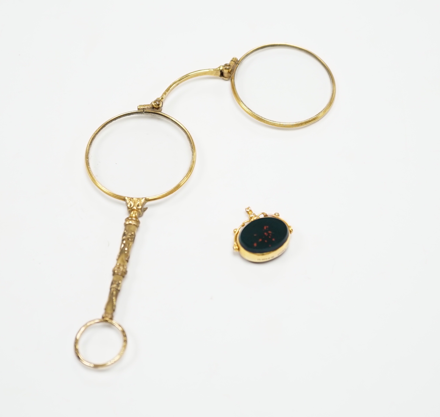A George V 9ct gold mounted carnelian and bloodstone set spinning fob, width 21mm, together with a pair of gold plated lorgnettes.